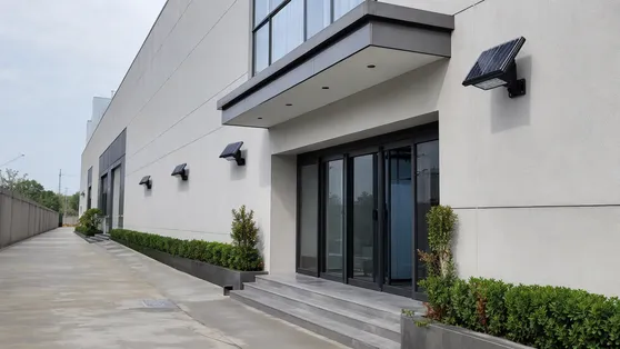 Solar wall mount fixtures for building perimeter and entrance lighting