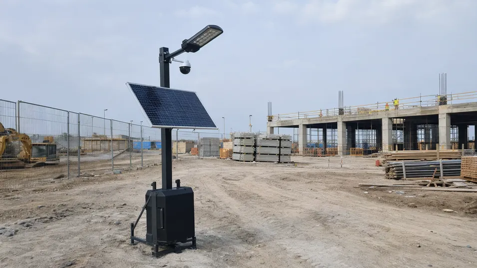 Portable solar street light with camera deployed at a construction site for temporary security lighting