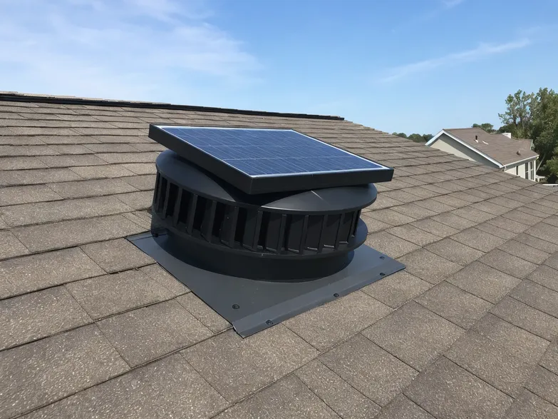 Solar attic exhaust fan installed on residential roof showing panel and louver assembly for building material distributor channel