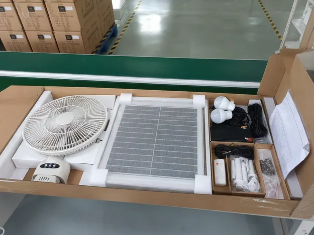 Solar fan with LED light kit export packing layout showing foam-wrapped panel, fan body, and accessories in sequence