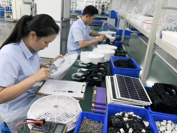 Quality inspection of solar powered fan kit components at JXSOL factory