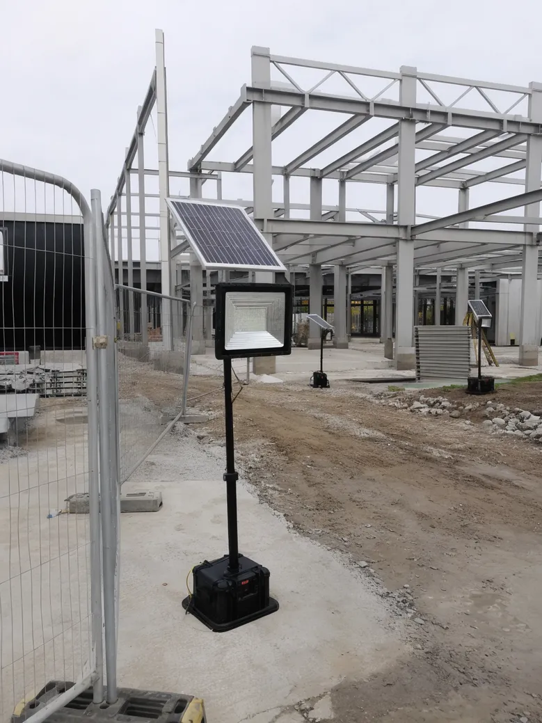 Portable solar flood lights deployed at an active construction site