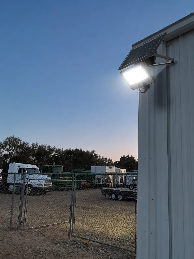 Solar flood light with motion sensor securing a vehicle storage compound
