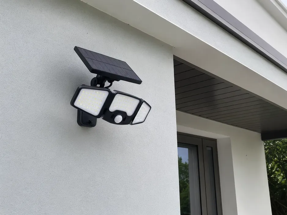PIR solar security light with passive infrared sensor mounted on exterior wall