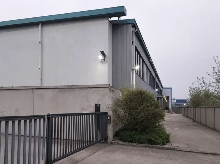 PIR solar security lights installed at warehouse perimeter blind spots covering gate approaches and secondary access points