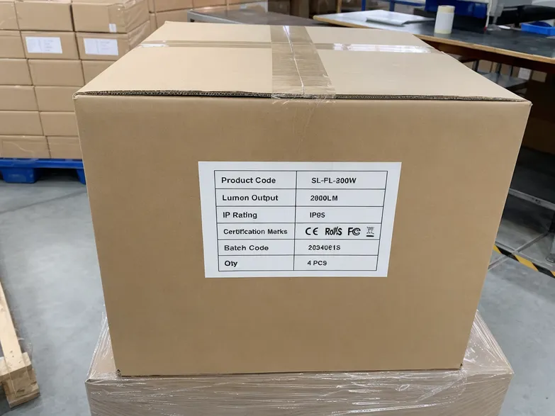 Solar LED flood light carton with batch code, product code, lumen output, and certification marks visible on label