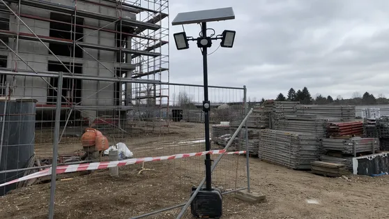 Temporary solar motion sensor flood light deployed on an active construction site