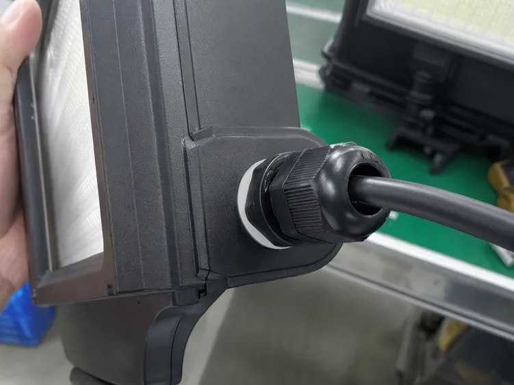 Close-up of IP67-rated cable entry gland and gasket seal on a waterproof solar security light housing