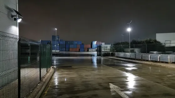 Waterproof solar security lights illuminating an outdoor logistics storage yard at night