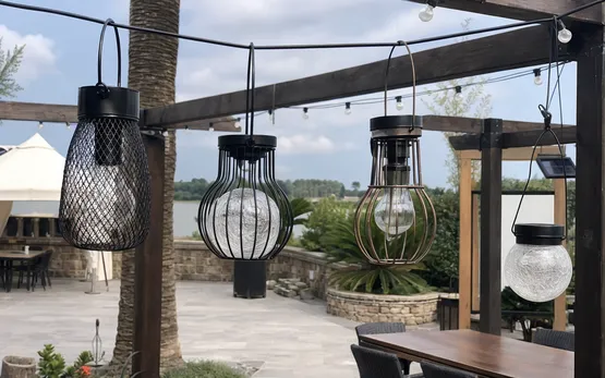 Hanging solar lights with decorative globe and cage designs on hanging wire