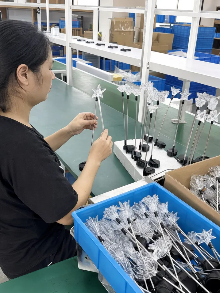 Structural quality check on decorative solar garden light wire stems and acrylic diffusers at JXSOL factory
