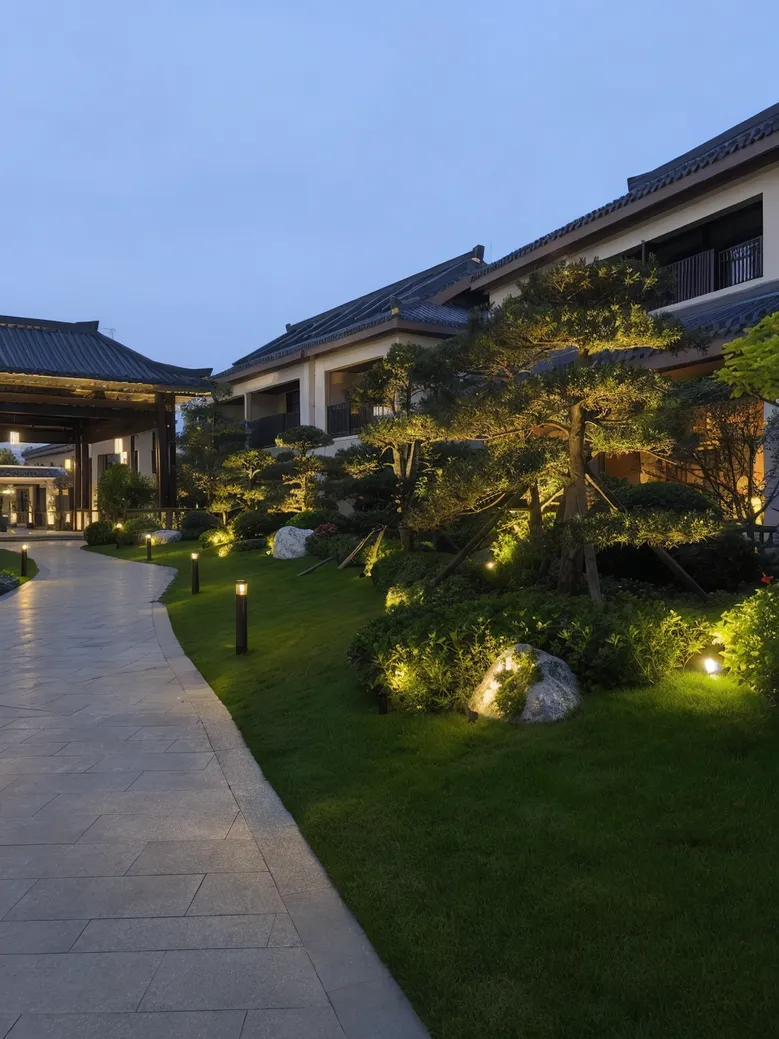 Solar garden lights illuminating a resort hotel landscape at dusk