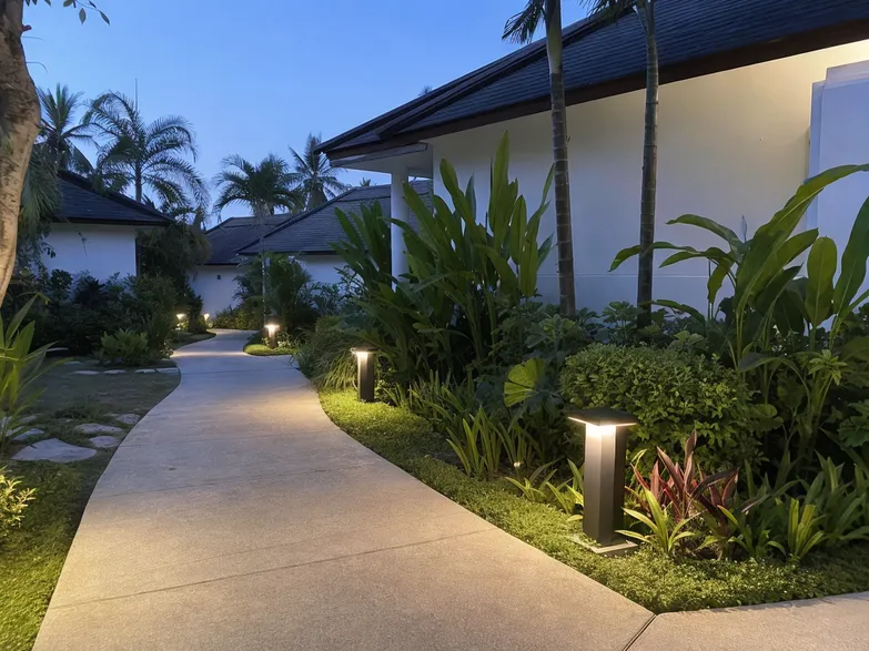 Warm white solar landscape lighting along a resort garden pathway at dusk