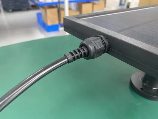 Compression-sealed waterproof connector at solar panel-to-cable junction showing strain relief design