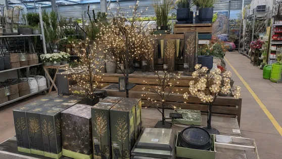 Solar tree light retail display in a garden center aisle