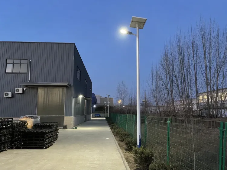 Solar area light mounted on pole illuminating industrial compound perimeter and equipment yard