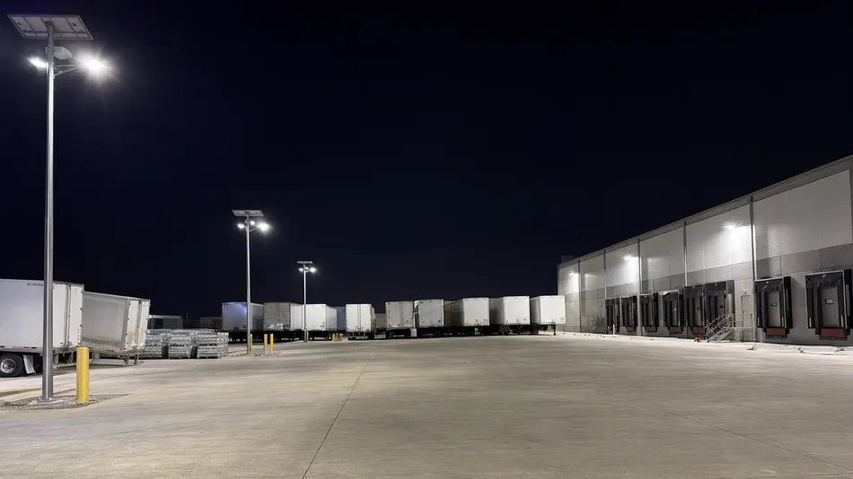 High-output solar area lights illuminating a logistics yard with loading docks