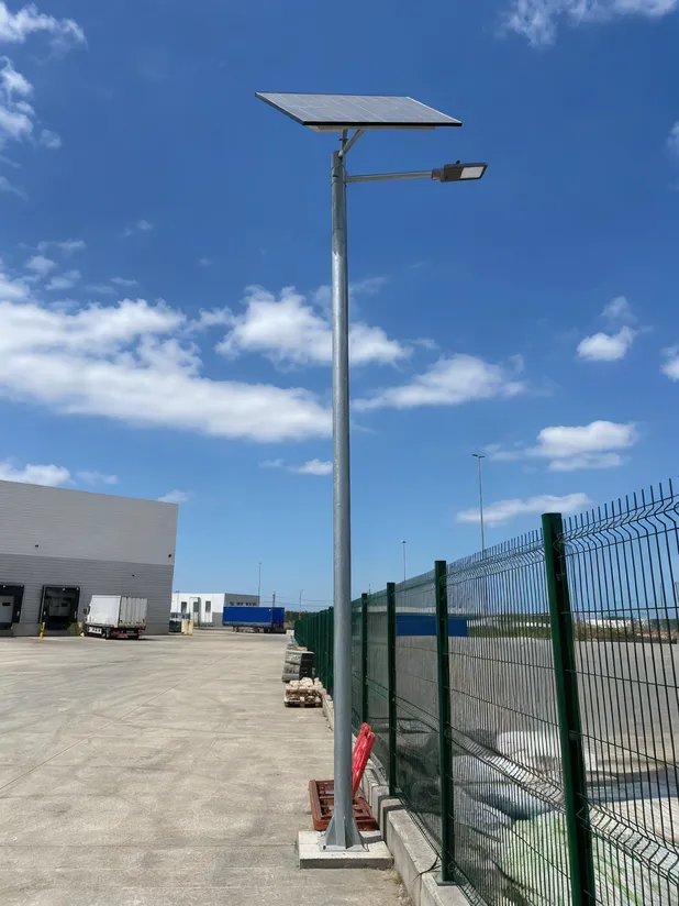 Pole-mounted commercial solar area light fixture in an open logistics yard