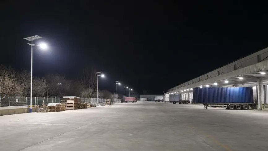 Solar area lights illuminating a logistics yard and loading dock at night