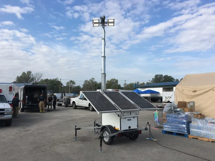 Solar lighting tower deployed at an emergency response staging area providing grid-independent illumination