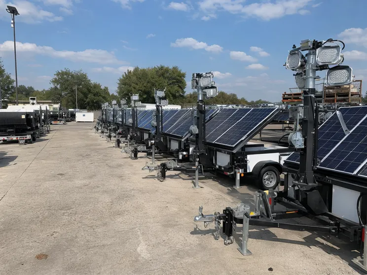 Fleet of solar lighting towers staged at a rental yard ready for deployment to multiple customer segments