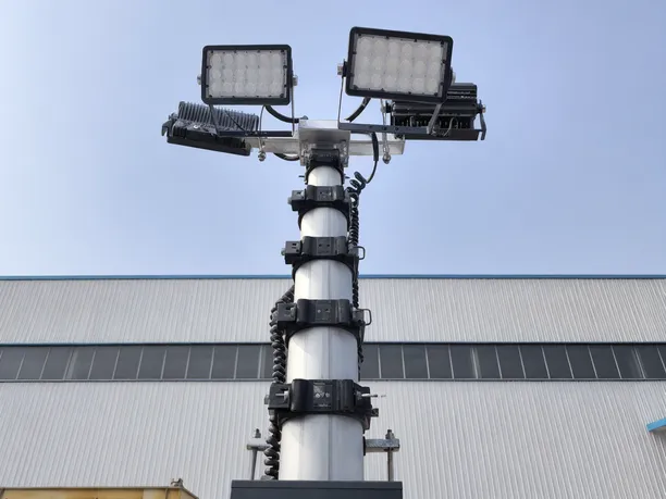 Close-up of a solar lighting tower telescoping mast mechanism with LED floodlight array at the top