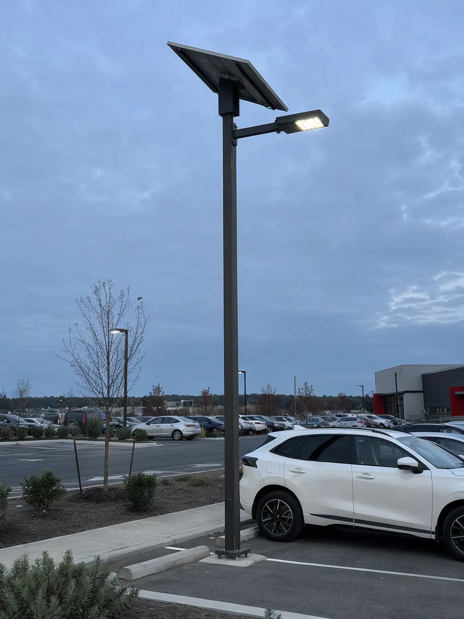 JXSOL solar parking lot light installed on a commercial parking lot pole at dusk