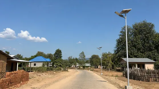Solar pole lights installed along a rural village road in an off-grid area