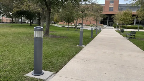 Solar bollard lights retrofitted on a university campus pathway