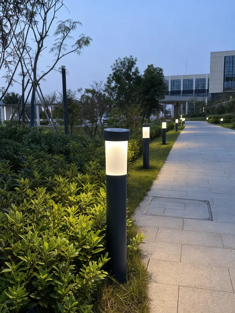 JXSOL solar bollard lights installed along a commercial pathway at dusk