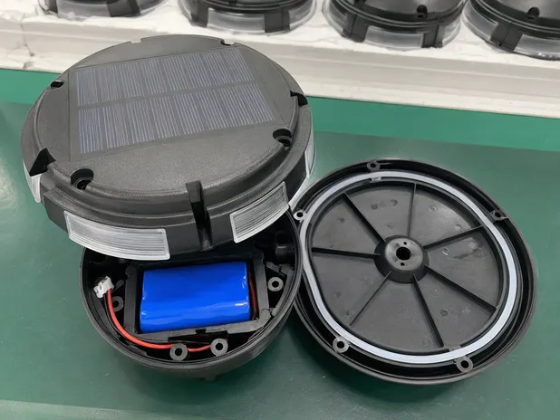 Solar deck light showing monocrystalline panel, LiFePO4 battery compartment, and IP67-rated housing