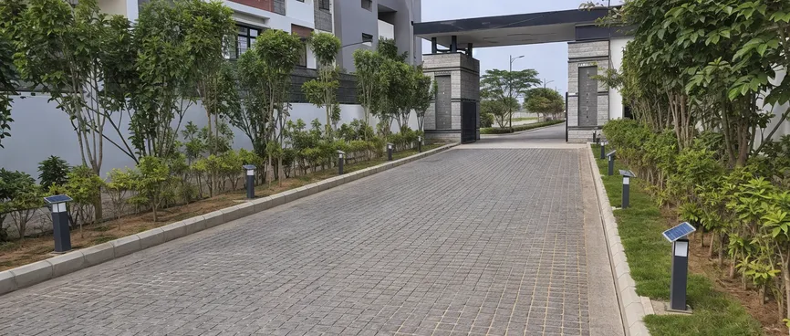 Solar driveway lights installed along a gated villa community entrance road