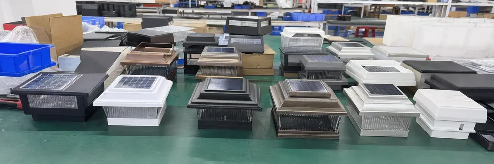 Custom private-label solar fence light housing samples in multiple colors and finishes on production table