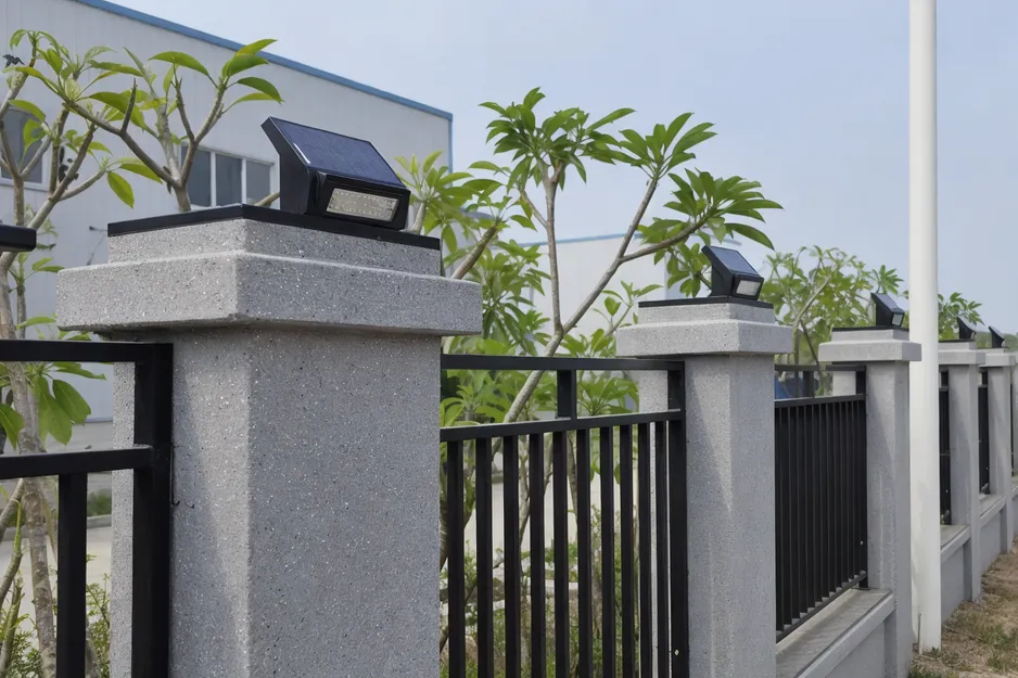 Solar fence lights mounted on perimeter fence posts showing compact integrated solar panel and LED module