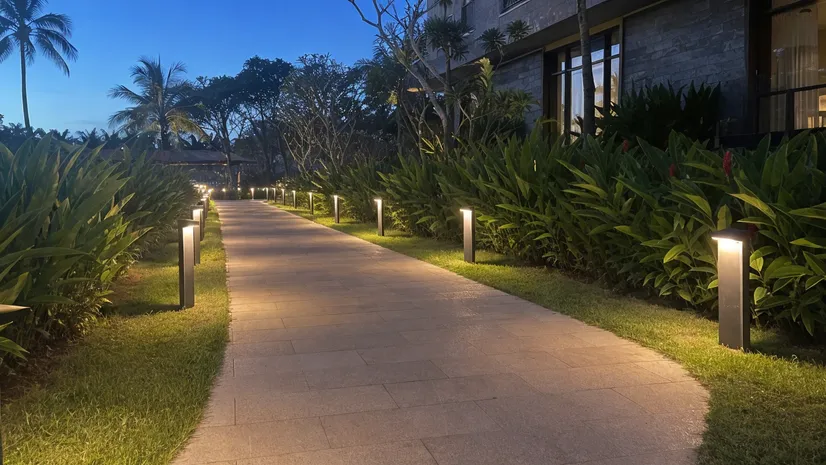 Solar walkway lights installed along a hotel resort pathway with consistent warm CCT across the full run