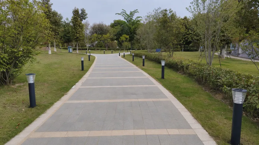 Solar walkway lights lining a public park path in a municipal installation
