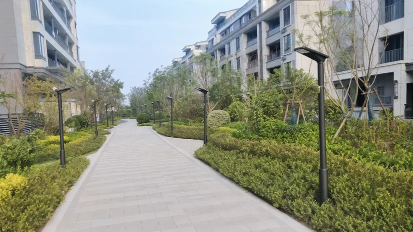 Solar walkway lights in a residential community development with uniform spacing along pedestrian paths
