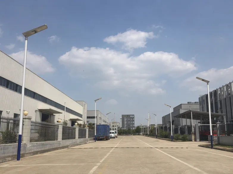 All-in-one solar street lights installed along an internal road in an industrial park compound