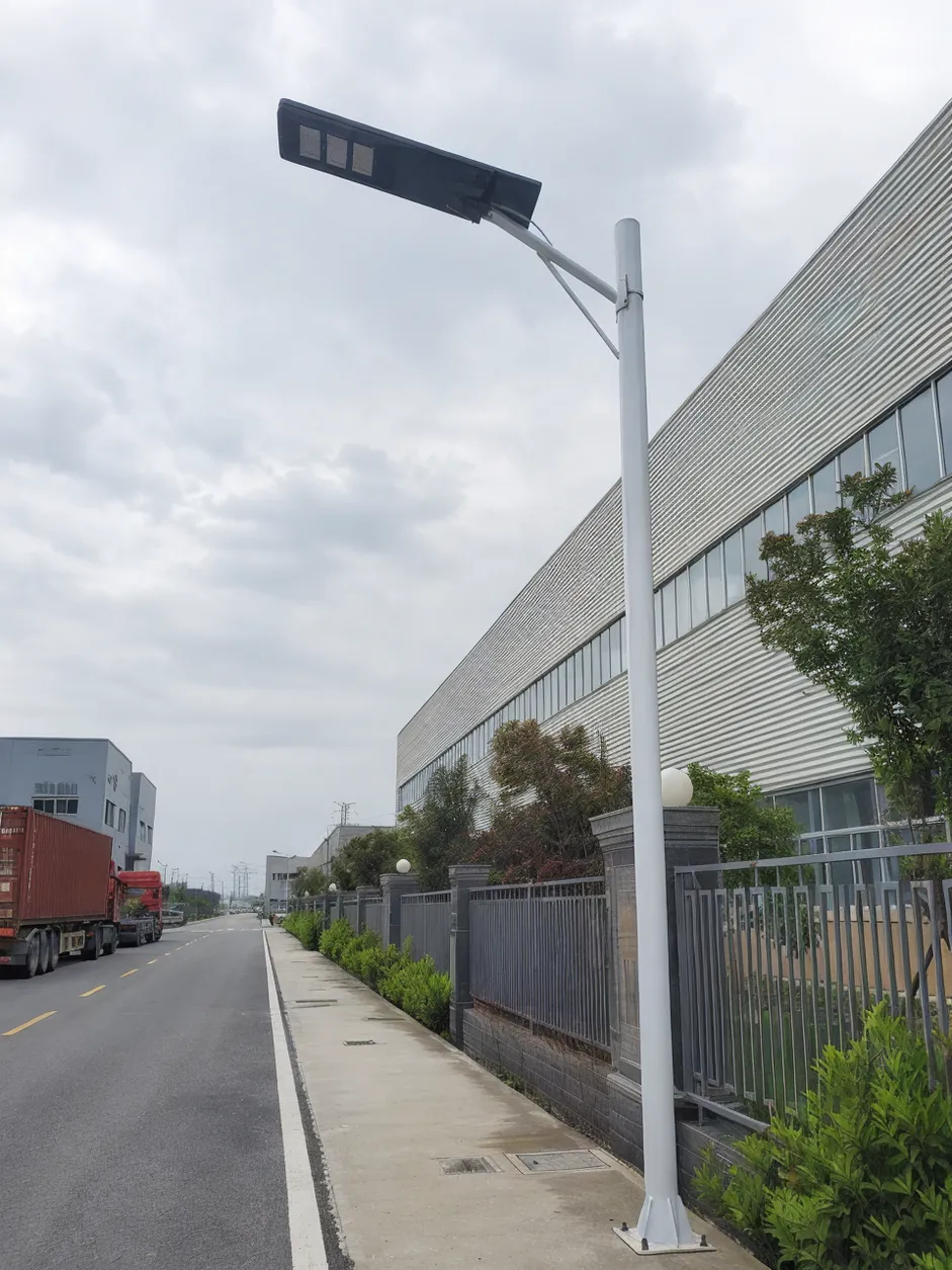 JXSOL commercial solar street light installed on an industrial road with LiFePO4 battery and IP67 weatherproof housing