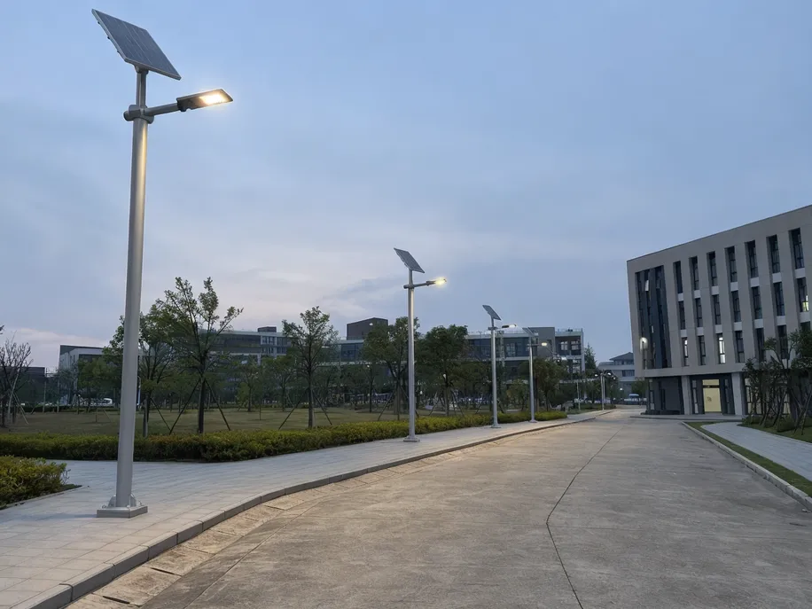 Solar street lights with scheduled dimming on a university campus private road network
