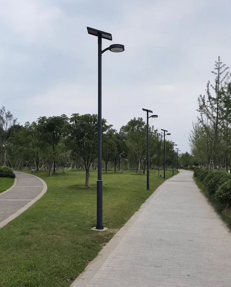Municipal park with phased solar lighting installation showing consistent fixture design across multiple trail sections