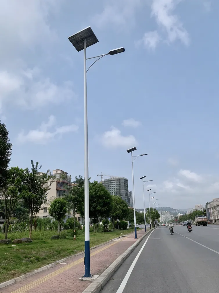 Municipal street lighting upgrade project with solar poles installed along a classified road