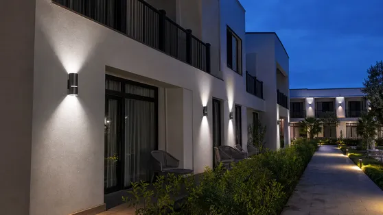 Up-down solar wall lights on hotel facade for decorative exterior illumination
