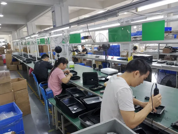 JXSOL solar wall lighting production line with workers assembling fixtures