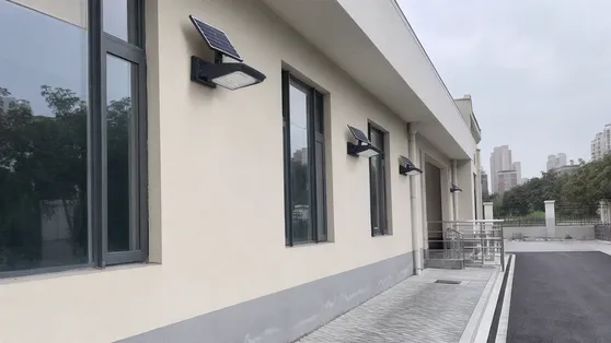 Solar wall lights on public building exterior for municipal facility lighting
