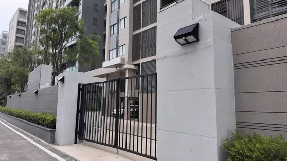 Solar wall lights installed on residential development building exteriors and entrance gates