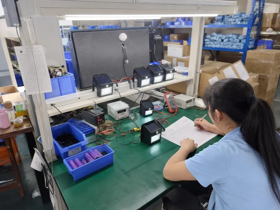 JXSOL quality control test bench for PIR sensor and battery verification on solar wall lights