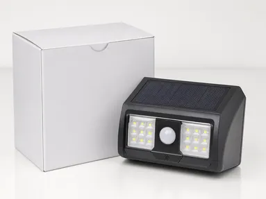 Compact motion sensor solar wall light in retail packaging for private label distribution
