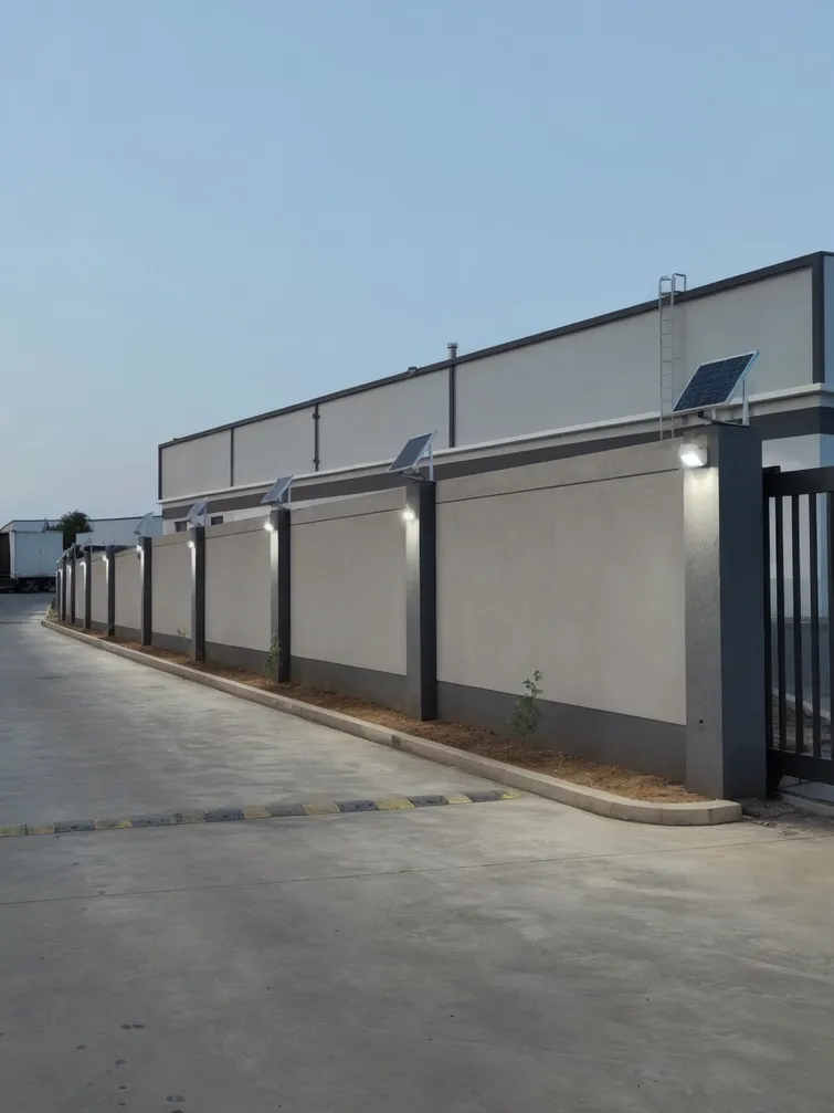 Separate-panel solar wall lights providing consistent perimeter illumination on a logistics park facility