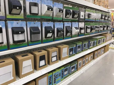 Solar wall lights retail display in a hardware store outdoor lighting aisle